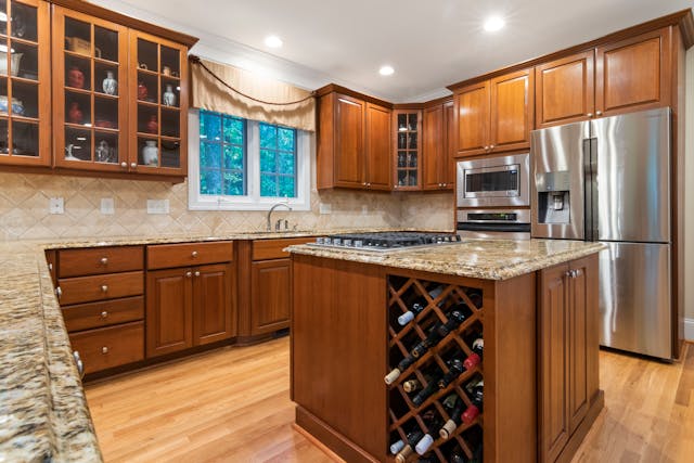 A renovated kitchen with wooden cabinets.